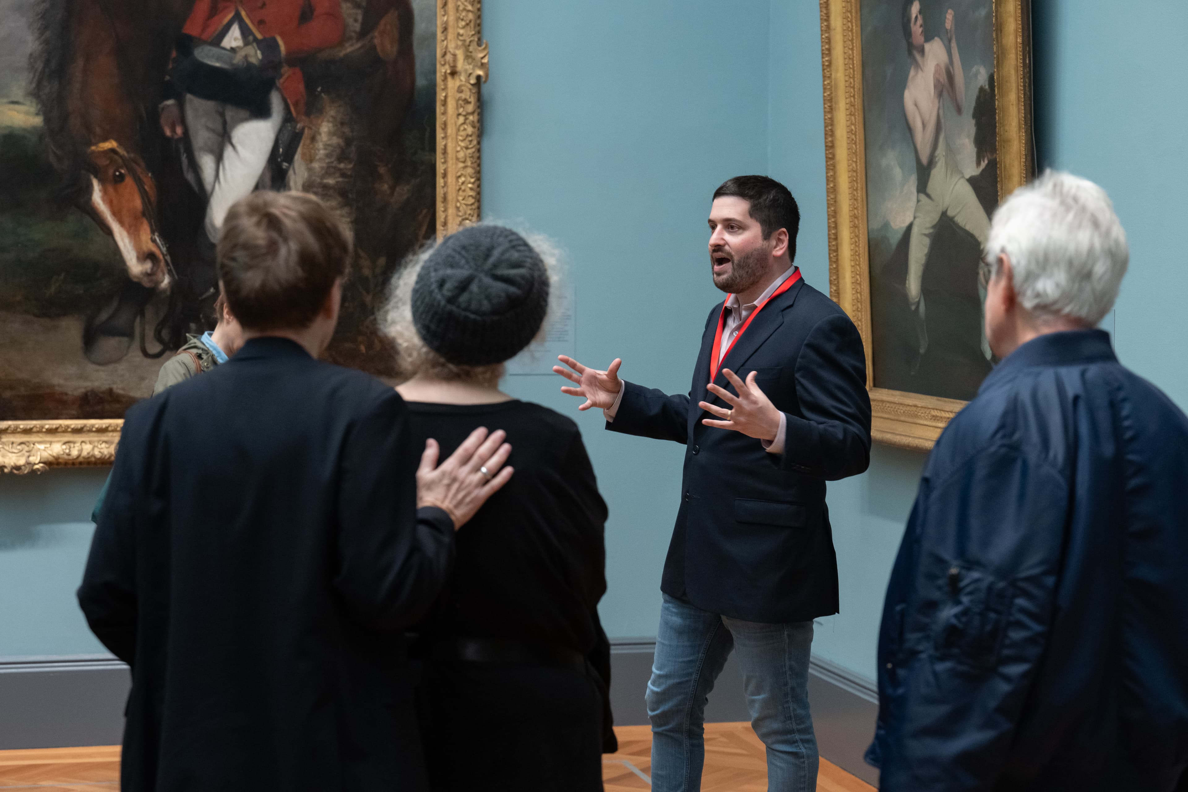 A group of visitors listening to a speaker, engaged in an Expert Talk